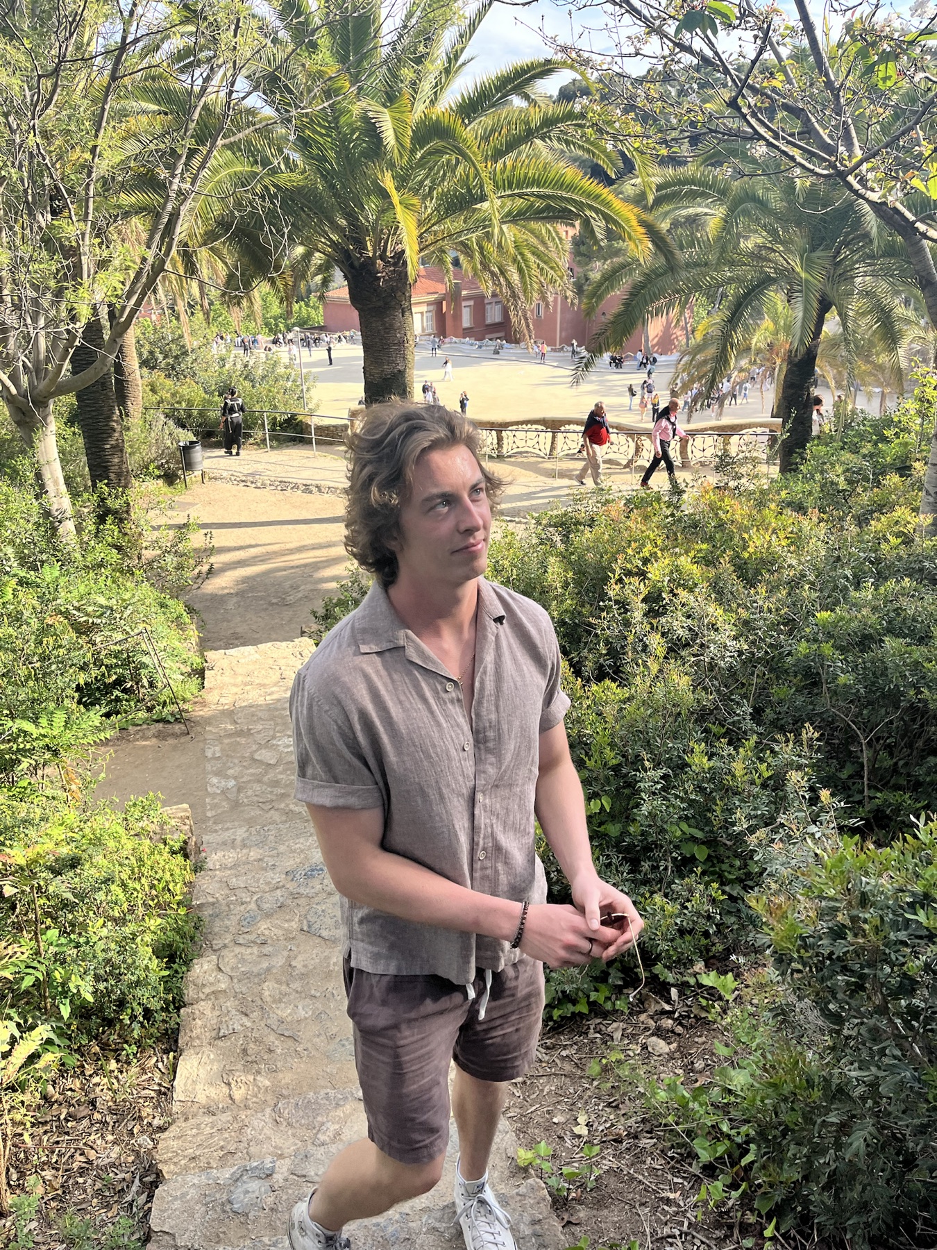 Jack walking through a palm-filled park in Barcelona